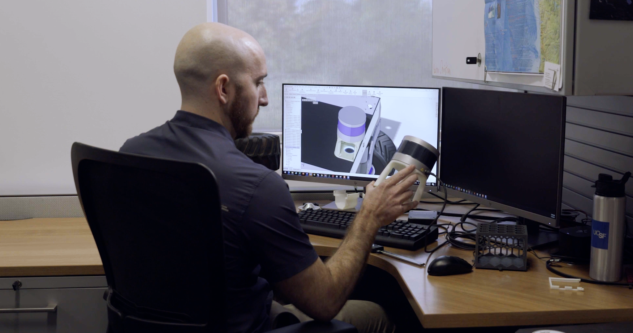 Aaron Christian compares his 3D printed LIDAR sensor mount with his digital CAD model.